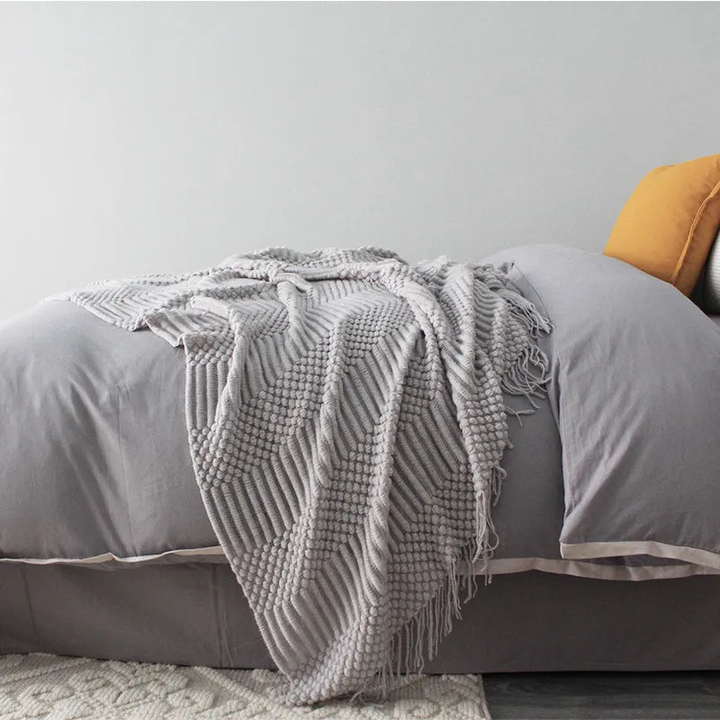 Small polyester nap blanket in dark grey, khaki, or light grey colours showing 127x170cm dimensions