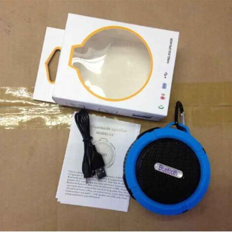 Colourful waterproof portable Bluetooth speaker with a black mounting buckle clip.