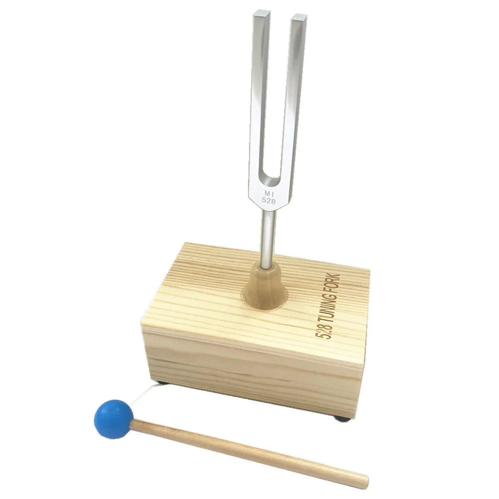 Aluminium alloy 432 Hz tuning fork with built-in speaker on kraft paper box.