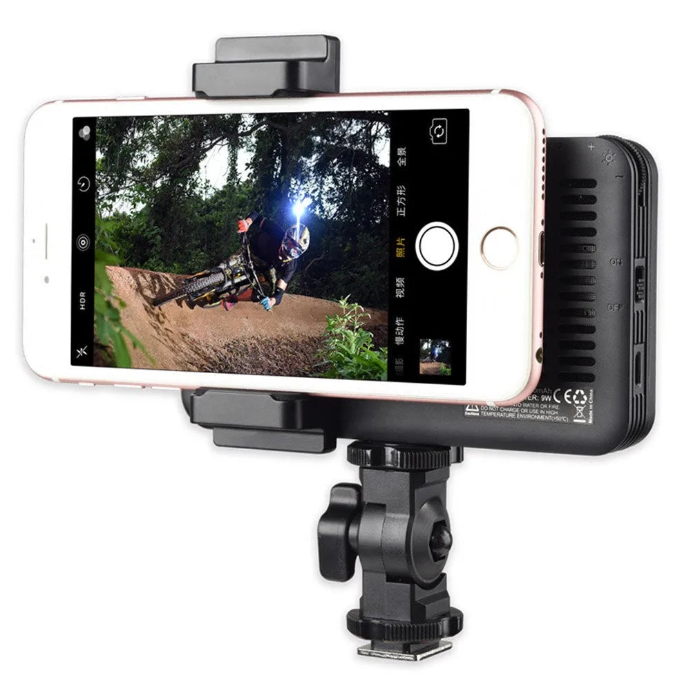 Shenniu M150 ultra-thin silver aluminium LED video light mounted on a mobile phone.