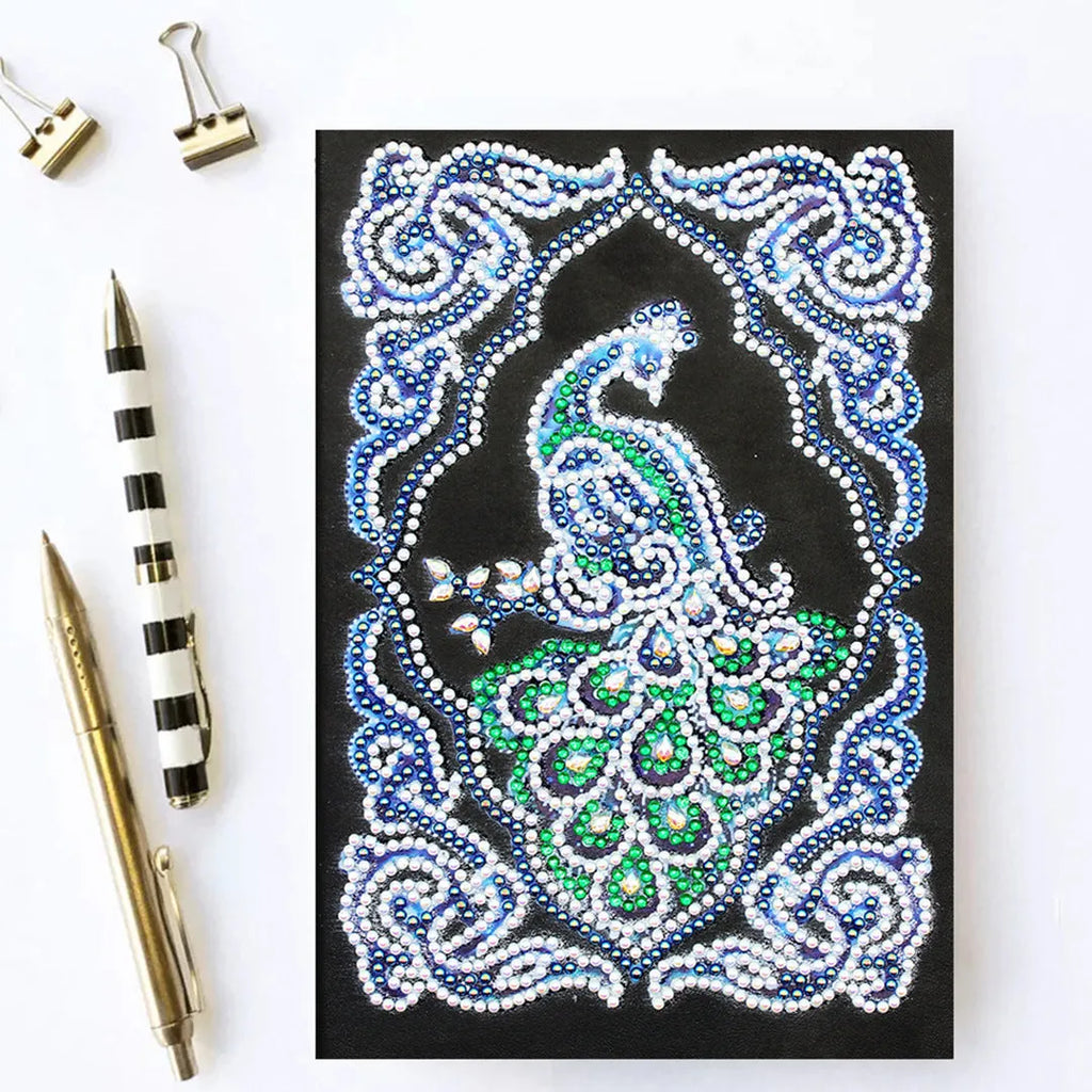 Black A5 diamond painting notebook with shaped and bright rhinestone designs on the cover.