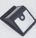 Set of four black solar-powered motion sensor LED lights for outdoor use.