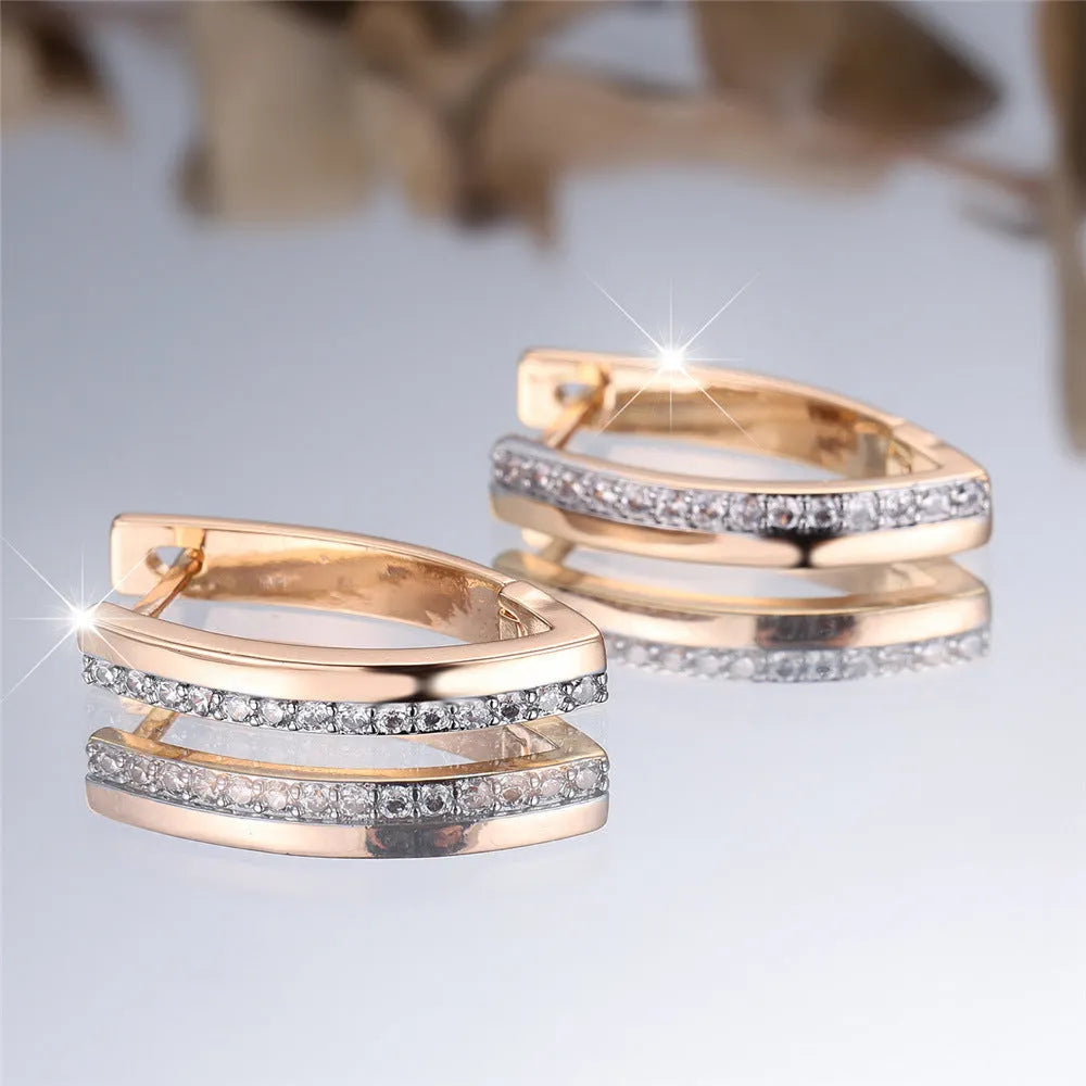 Geometric V-shaped champagne gold women's ear clips with white diamond accents.