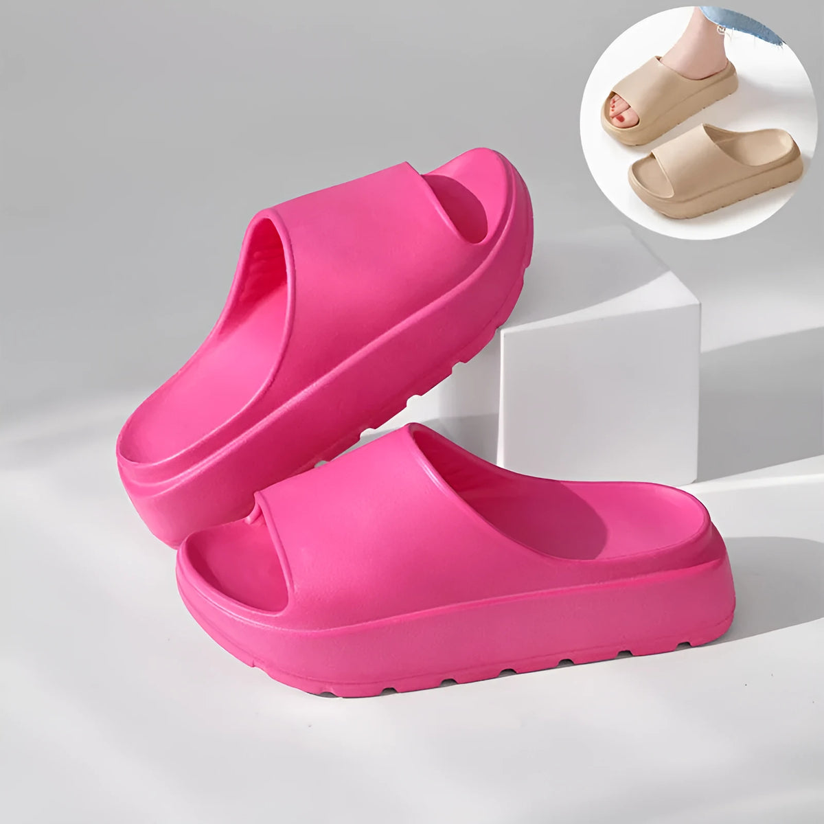 Women's thick-soled EVA beach slippers in beige, shown from the side on a sandy surface.