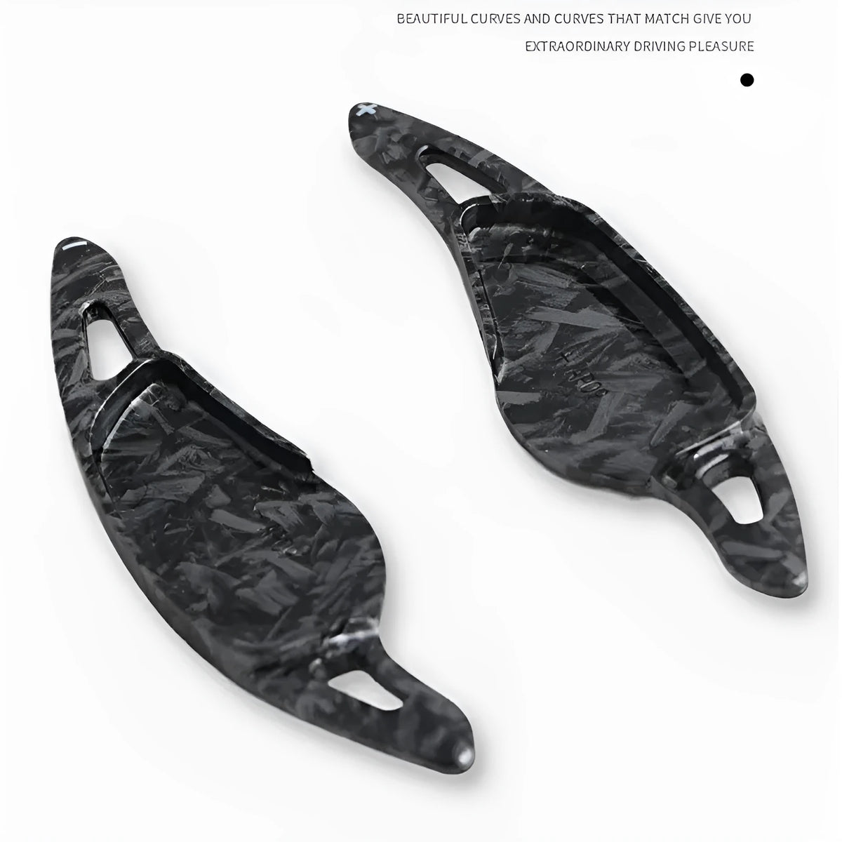 Steering wheel paddle shifter for car interior in various finishes including carbon fibre.