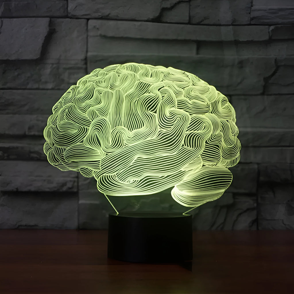 3D acrylic brain-shaped LED lamp with remote control on a wooden desk, projecting colourful light