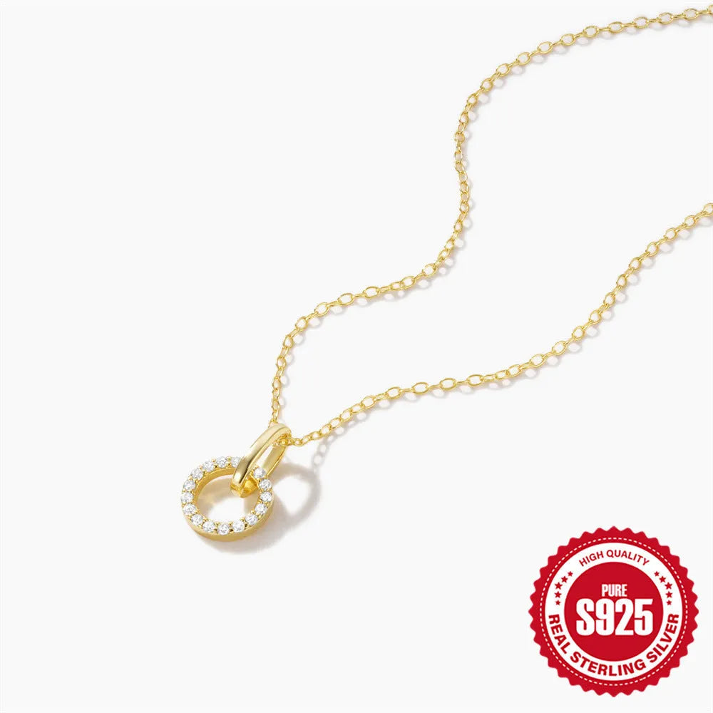 Gold-coloured sterling silver clavicle chain with interlocking geometric design and zircon stones