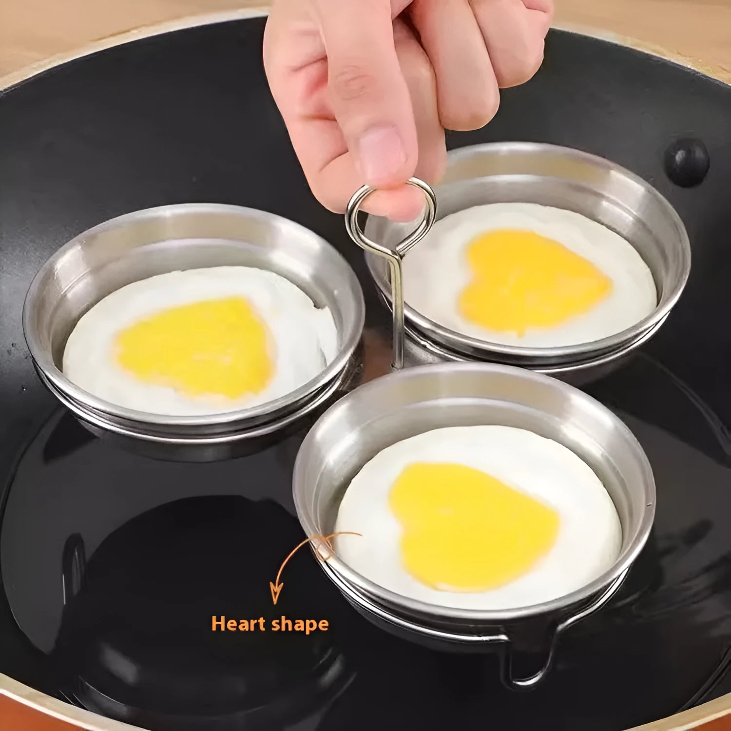 Stainless steel mini heart egg steamer kitchen appliance on countertop