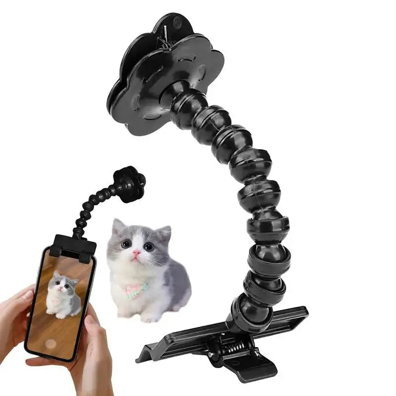 Black plastic pet photography tool with treat clip and phone holder, shown rotated to adjust angle.
