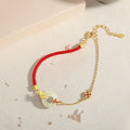 Gold electroplated Koi Peace Buckle Hetian Jade Red Rope Bracelet with safety clasp and animal zodiac design