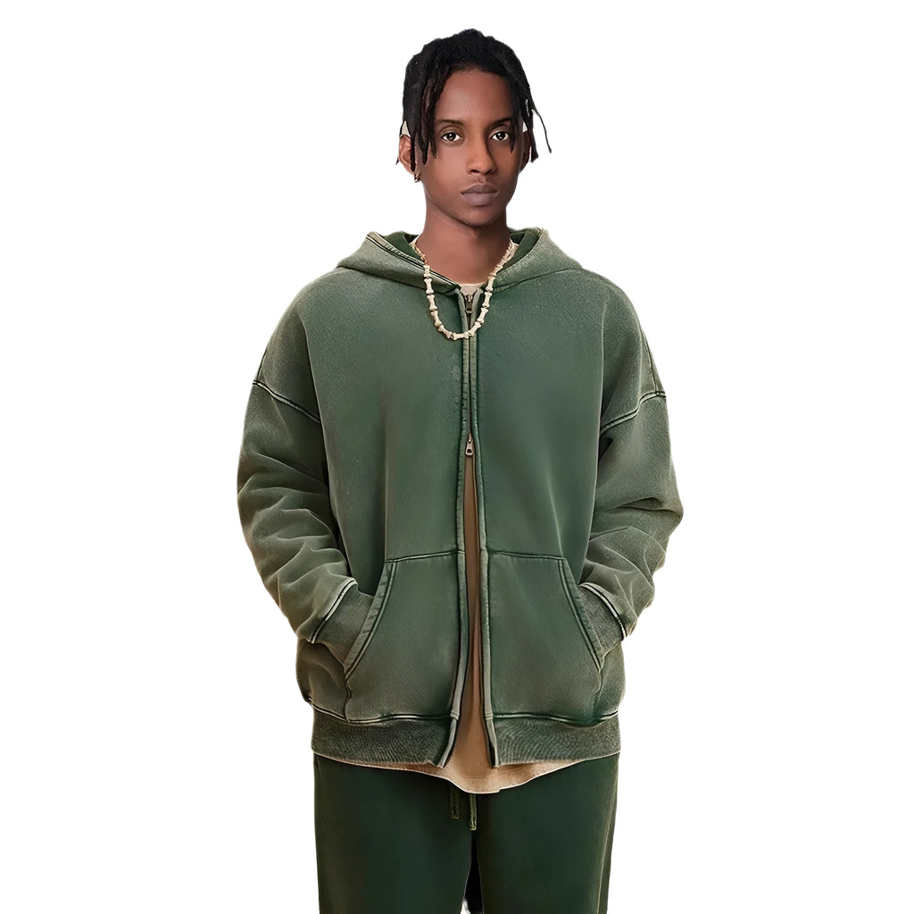 Man wearing a dark green fleece-lined hooded cardigan sweater with a double zipper.