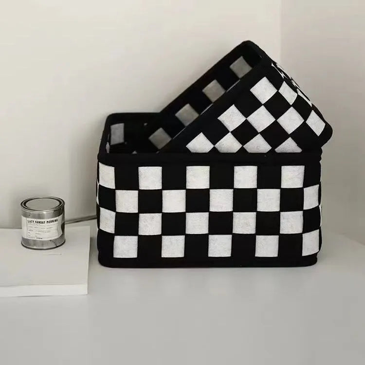 Checkerboard patterned grey felt folding storage basket shown upright and collapsed flat.