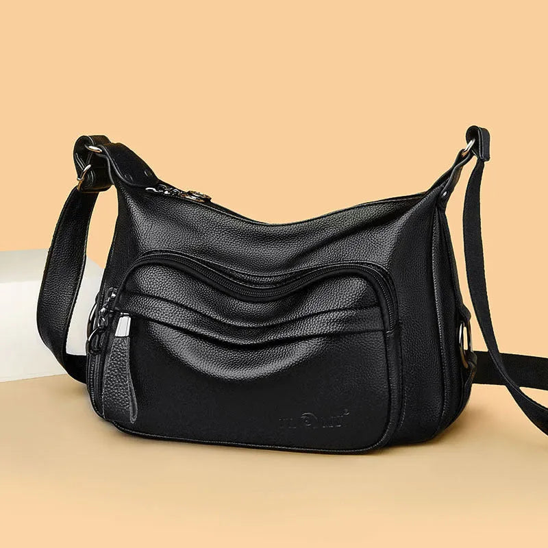 Large black or blue PU crossbody bag with organised internal compartments and soft handle
