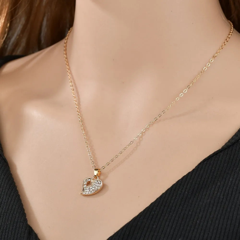 Women's love jewellery set with earrings, pendant and bracelet in gold colour with water drop and bell patterns