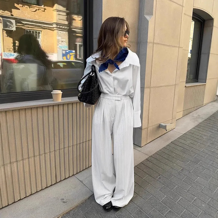 White striped wide-leg casual trousers with a zip closure on a hanger