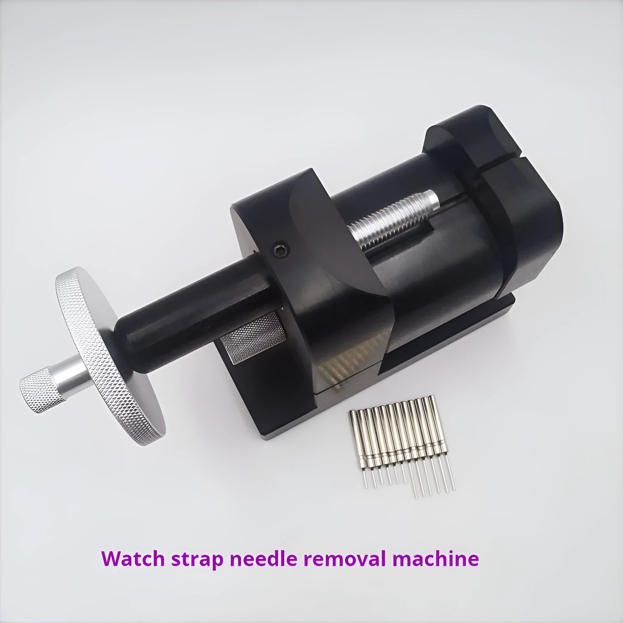 Steel alloy watch strap removal tool with spring mechanism on a work surface