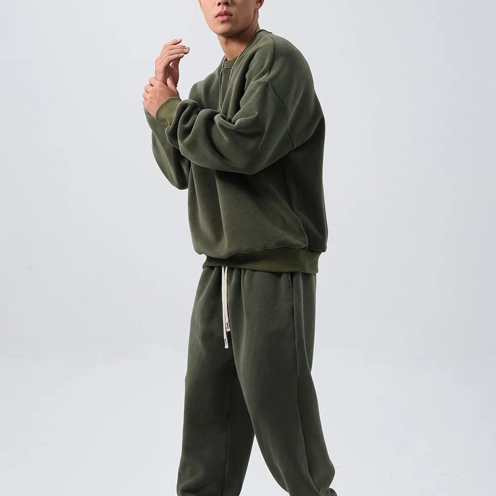 Men's black polar fleece sports suit with crew neck coat and padded trousers on a hanger