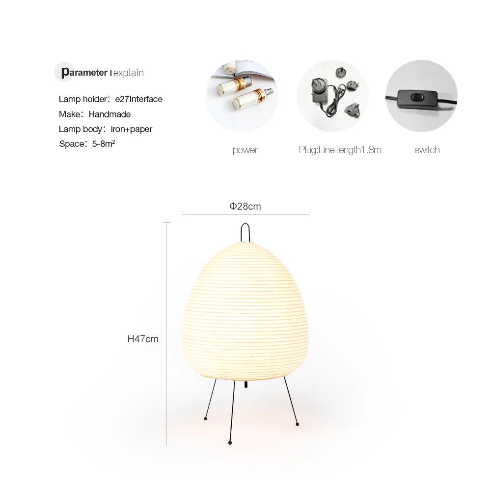 Japanese style table lamp with a white rice paper lantern shade and a silver aluminium base on a wooden table.