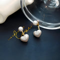 Heart-shaped pearl stud earrings with artificial gemstone accents on electroplated alloy settings