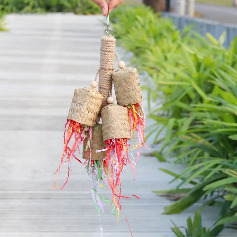 Colourful shredded paper parrot toy with wood and sisal construction measuring 15cm by 35cm