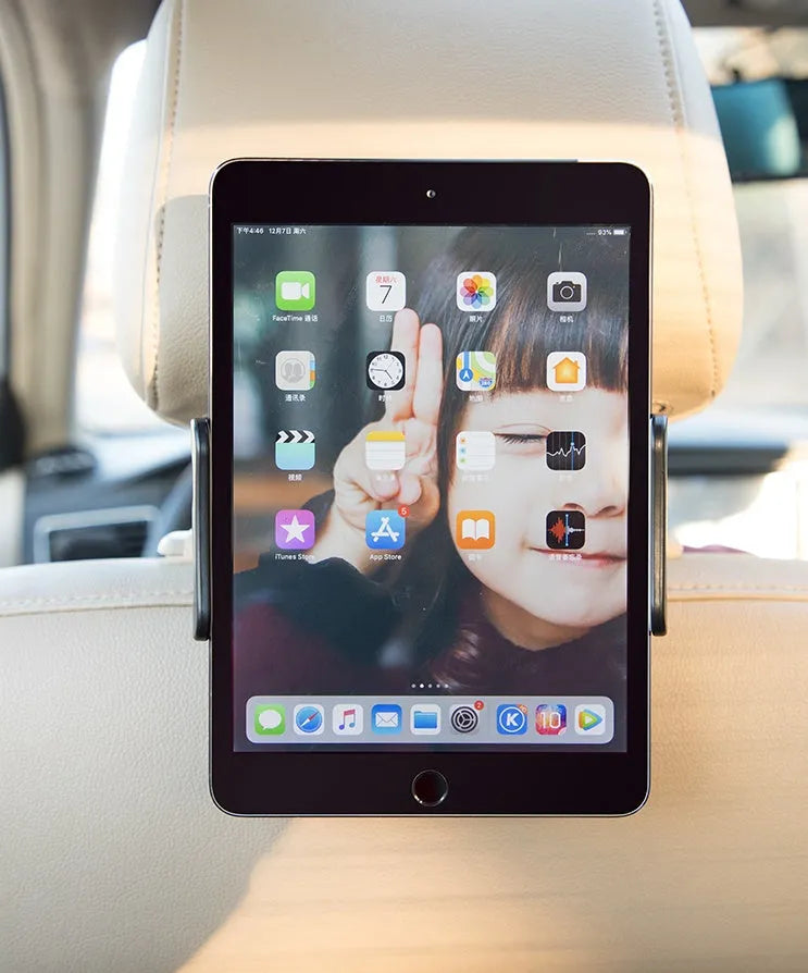 Black universal car phone holder mounted on a rear car seat, holding a tablet for navigation.
