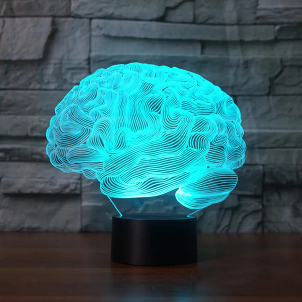 3D acrylic brain-shaped LED lamp with remote control on a wooden desk, projecting colourful light