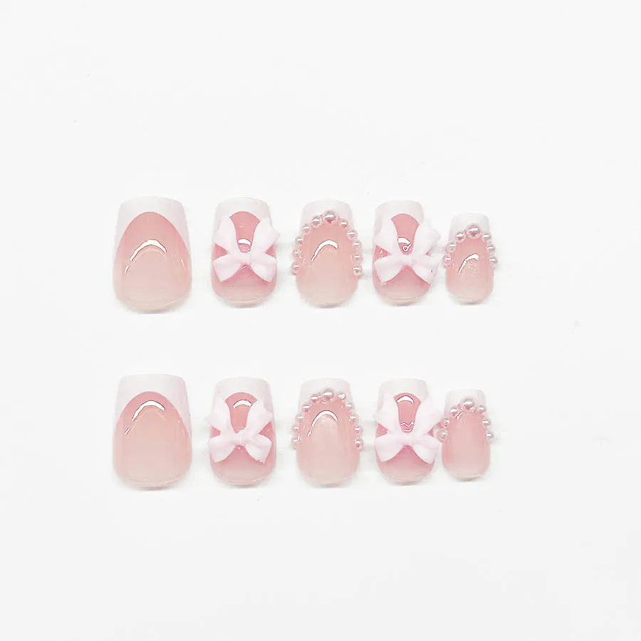 Short white square false nails with bow French manicure design and tulip patterns
