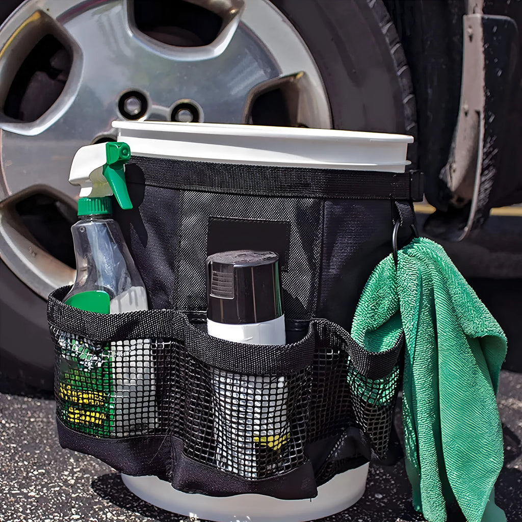 Black cylindrical polyester storage bag hanging on 5 gallon barrel for tool organisation