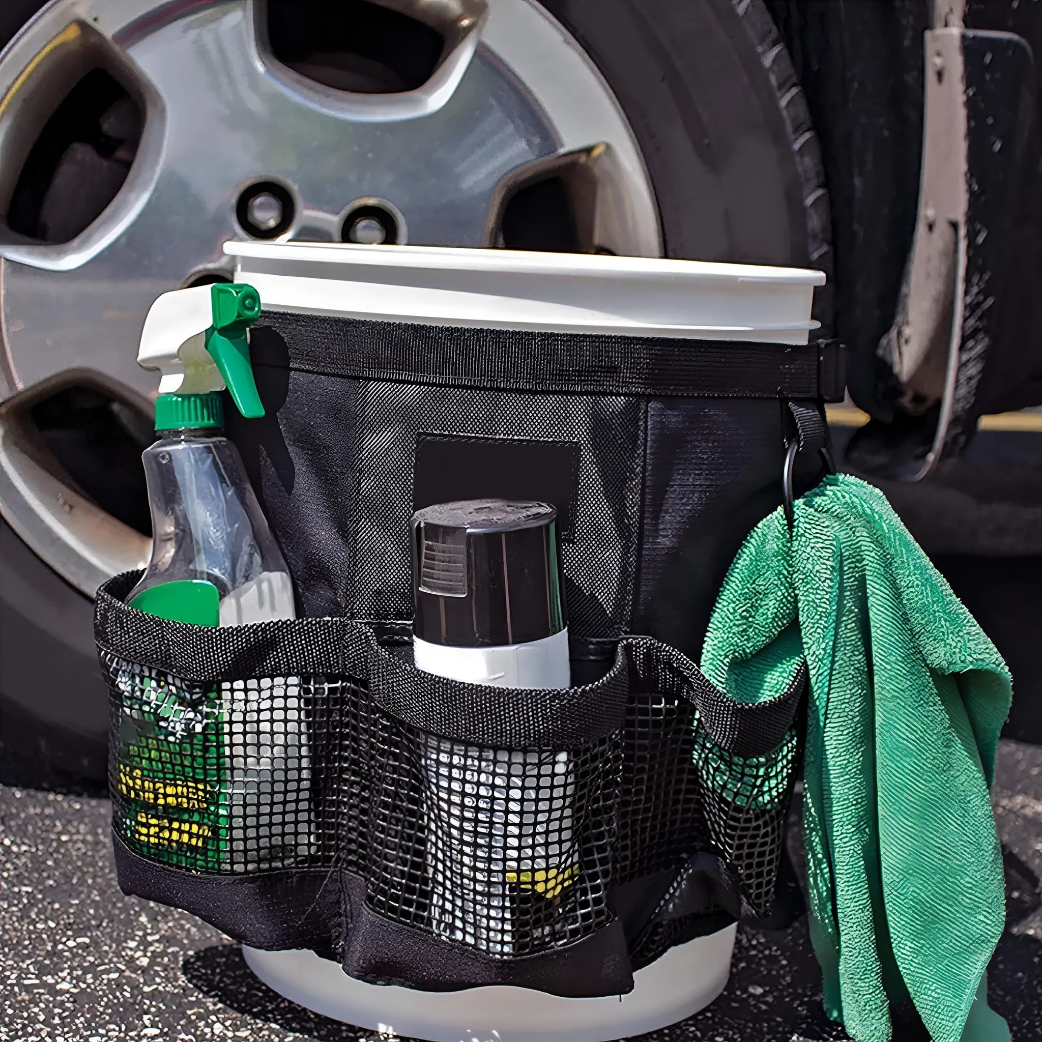 Black cylindrical polyester storage bag hanging on 5 gallon barrel for tool organisation