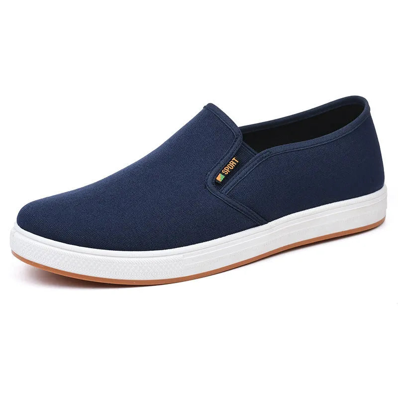 Men's low-top canvas slip-on shoes in blue colour showing round toe and shallow mouth design