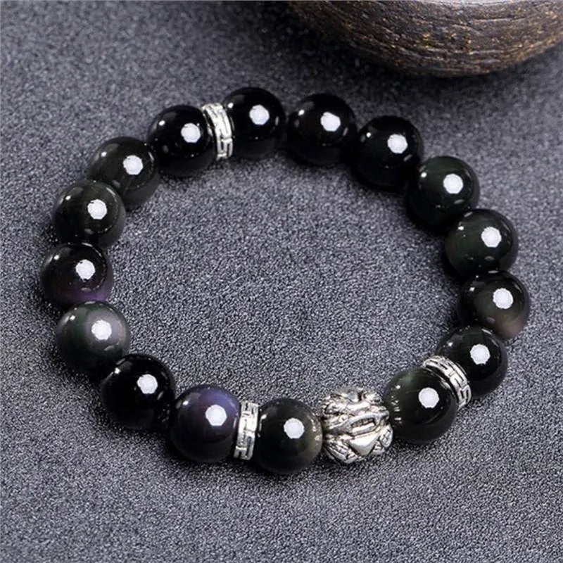 Natural obsidian bracelet with silver 999 clasp in 10mm or 12mm size on a wrist.