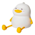 Chubby silicone night light lamp with phone holder on desk, showing soft LED glow and compact 108x104x128mm dimensions