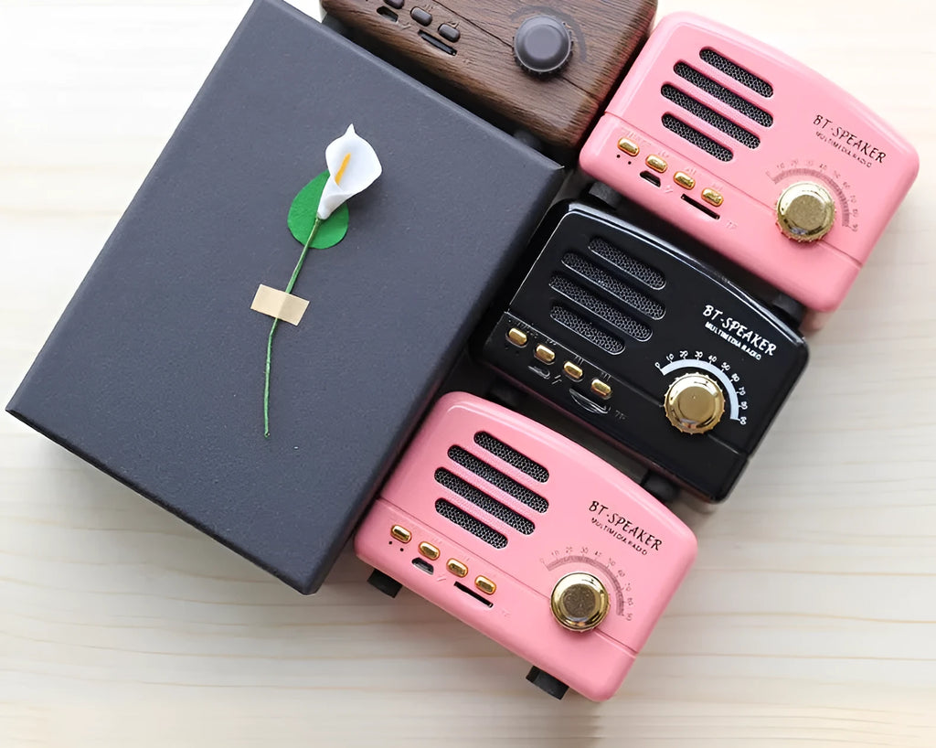 Vintage wood finish Bluetooth speaker in black, pink and wood grain colours showing compact 93x70x59mm dimensions