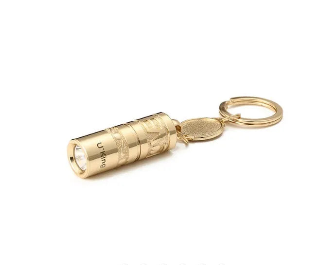 Gold-coloured waterproof zinc alloy portable LED flashlight on a keychain ring.