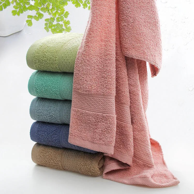Thickened cotton blend bath and beach towel shown in multiple colour options including green, blue, and pink variations.