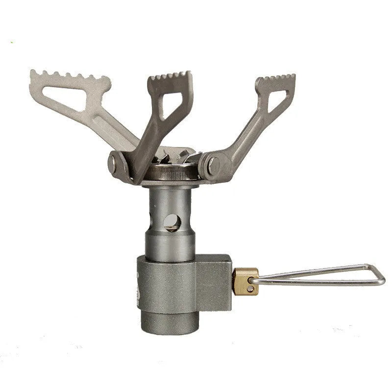 Portable metal camping gas stove with a one-piece burner, shown on a flat surface.