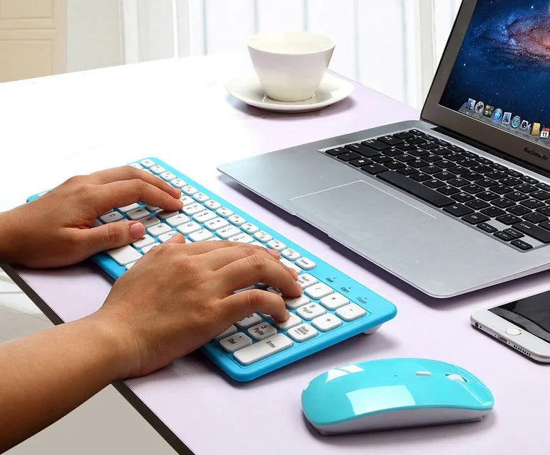 Black wireless keyboard and mouse set with full 96-key layout and USB receiver on a desk