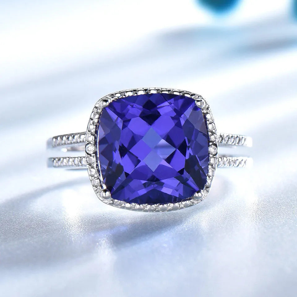 Blue tanzanite stone set in a sterling silver women's ring, shown in size 8.