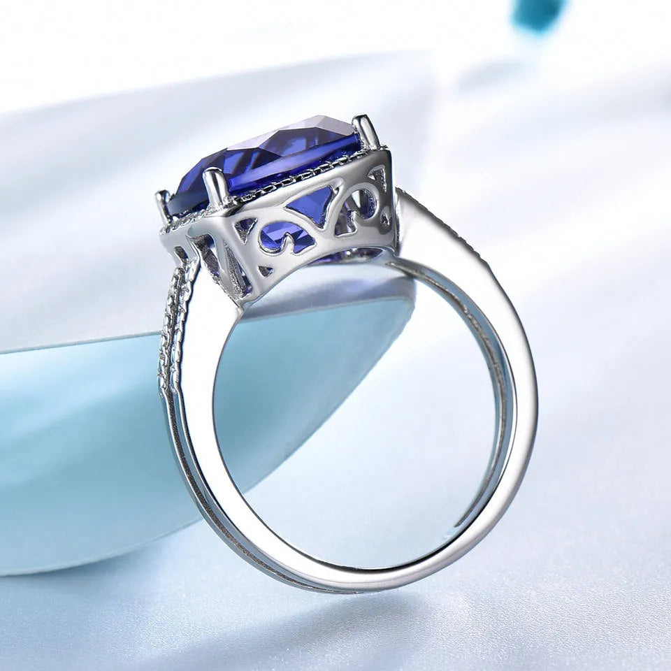 Blue tanzanite stone set in a sterling silver women's ring, shown in size 8.