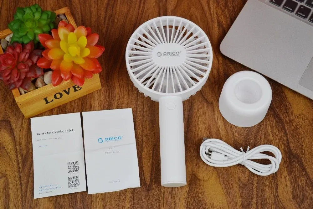 ORICO FH1 white portable USB rechargeable fan with three-speed settings on a desk.