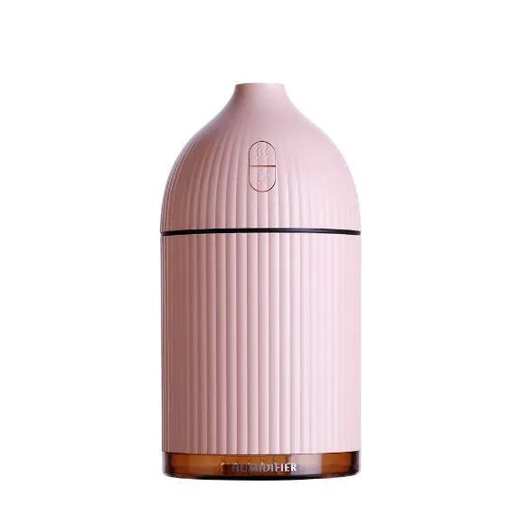 White ultrasonic aromatherapy diffuser humidifier with USB cable and LED light on wooden table