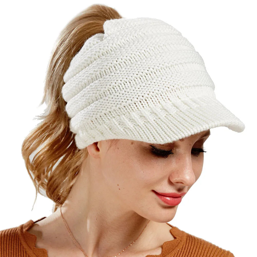 Women's soft acrylic ponytail beanie hat in various colours on a model with a ponytail.