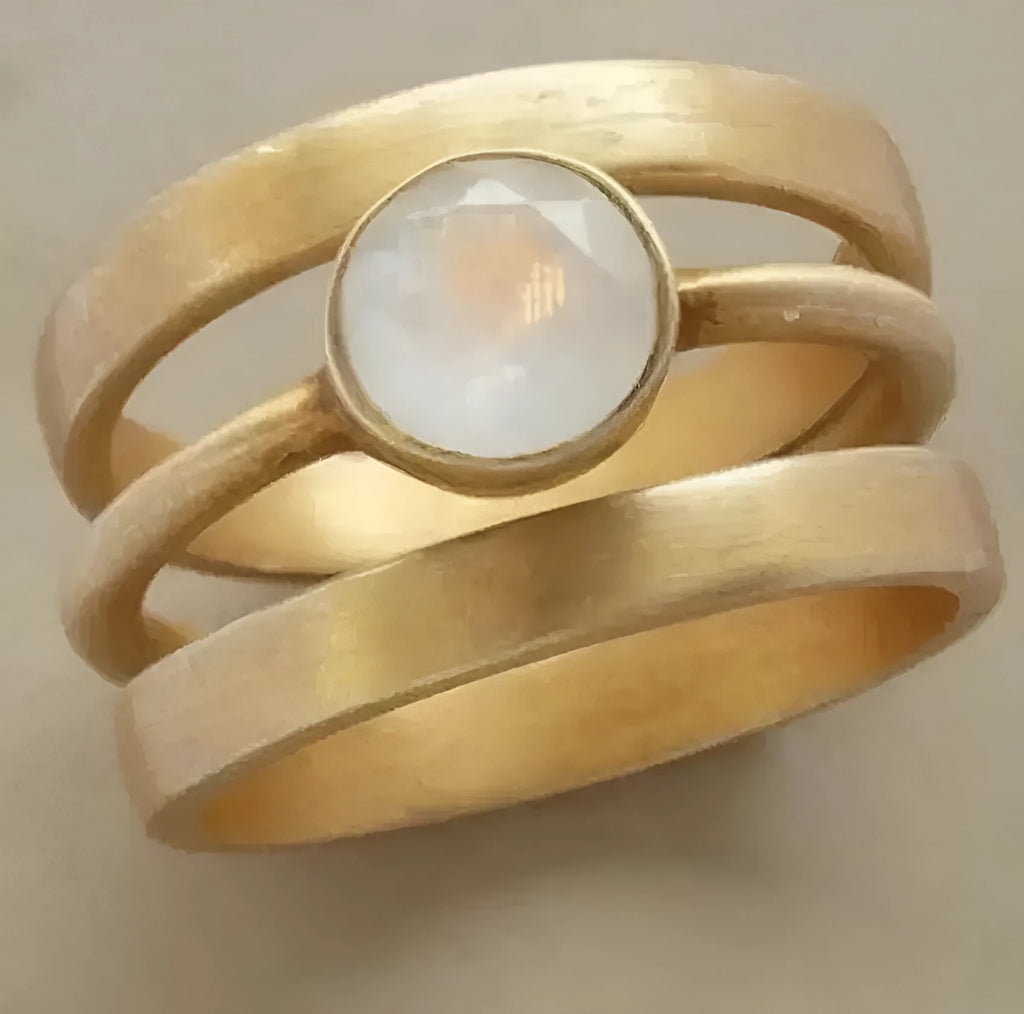 Gold-plated geometric titanium steel ring with hollow micro-inlaid white chalcedony detail.