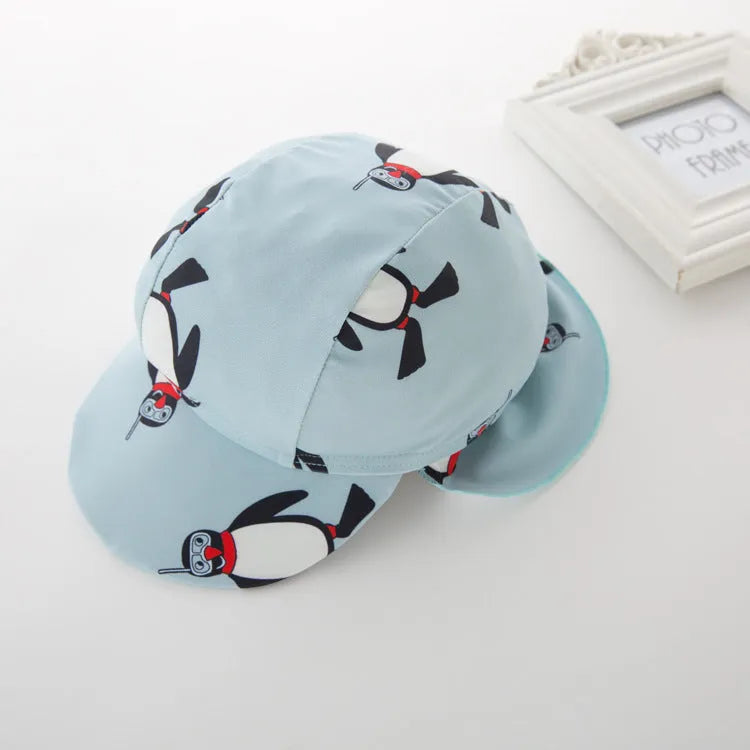 Boys' penguin print long sleeve swim shirt and matching swim cap set.