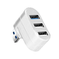 Black and white USB 3.0 hub with four ports and a rotating design on a desk.