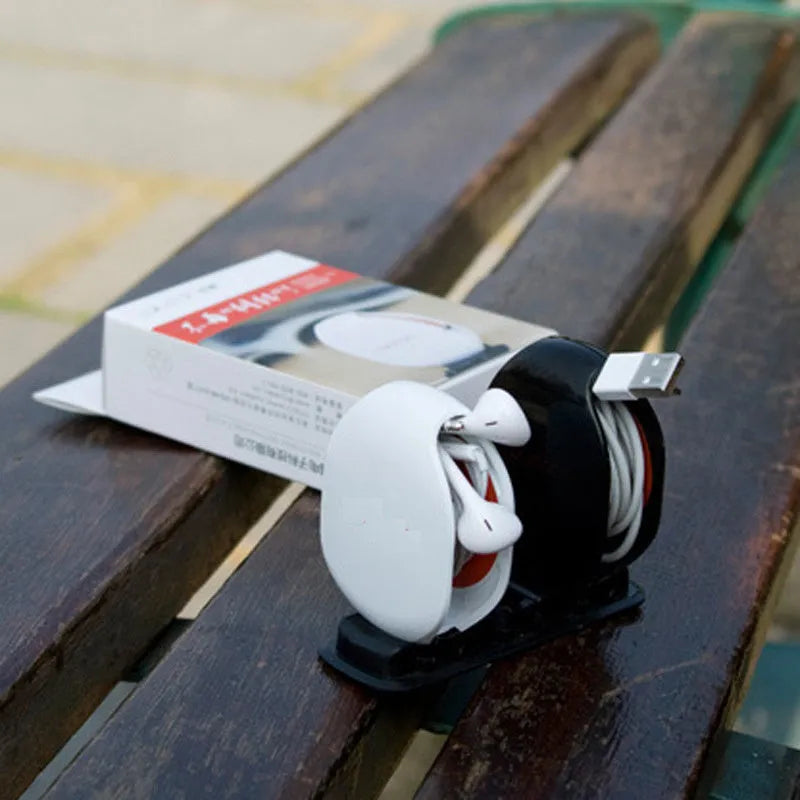 Automatic earphone cable winder retractor in various colours on a white background.