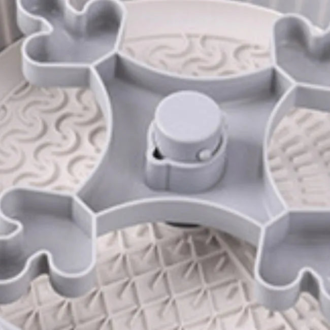 Rotating pet slow feeder bowl with game board surface and removable silicone licking mat in blue.