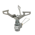 Portable metal camping gas stove with a one-piece burner, shown on a flat surface.