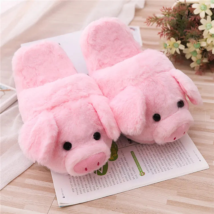 Pink pig-shaped floor slippers with short plush fabric and a soft padded interior.