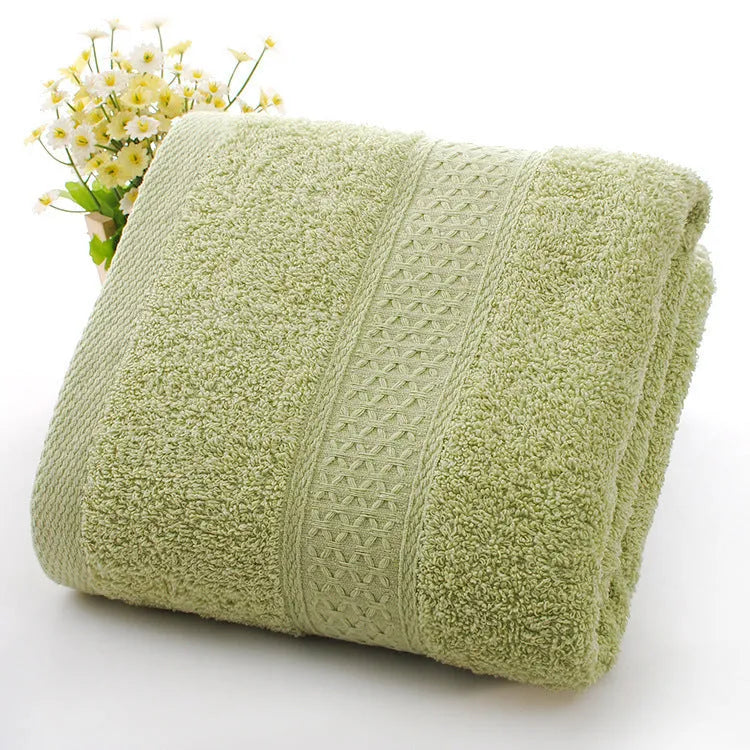 Thickened cotton blend bath and beach towel shown in multiple colour options including green, blue, and pink variations.